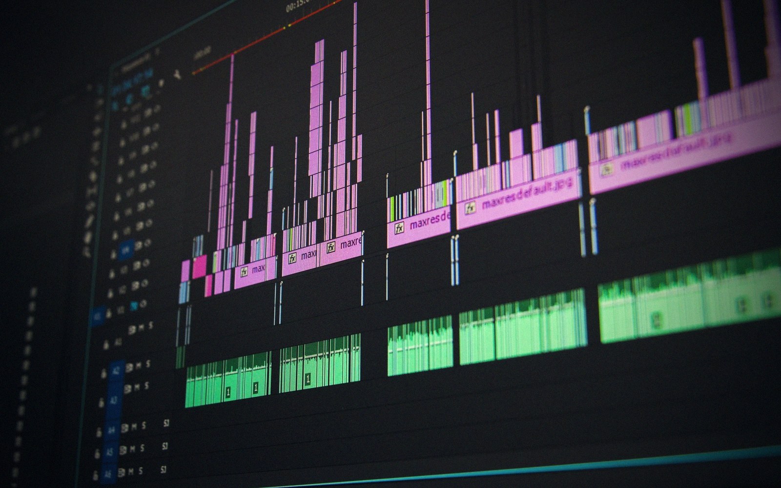Computer screen showing audio waveforms and clips in a video editing timeline