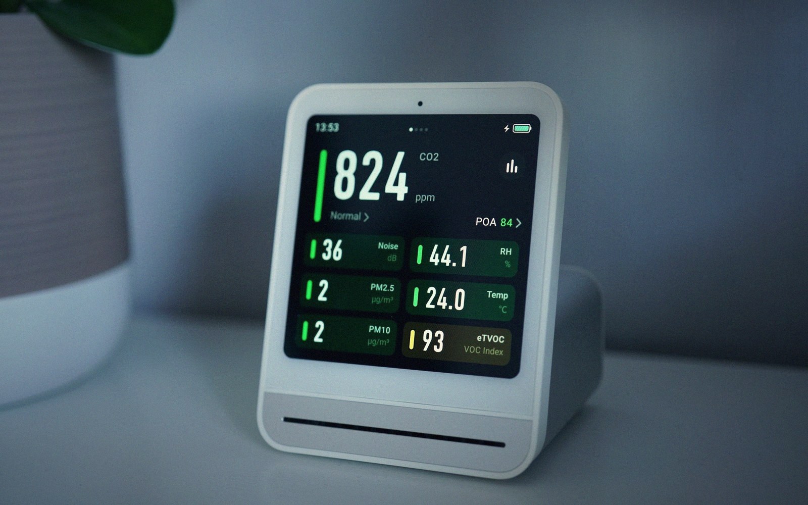 Air quality monitor displaying CO2, humidity, temperature, and VOC readings on screen